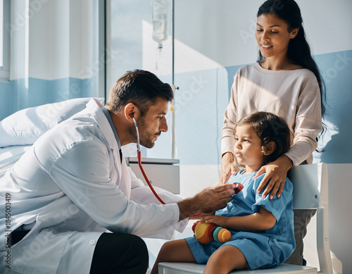 Caring Male Pediatrician Gently Examining a Healthy Baby During Medical Checkup in a Bright Modern Hospital Room, Showing Professional Healthcare, Child Care, and Trust Between Doctor and Infant