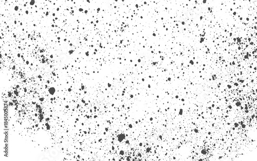 White background with scattered irregular dark gray speckles and splotches creating a grunge texture effect.