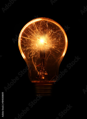 Glowing light bulb with sparks