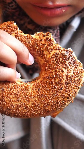 Enjoying a sesame bagel in a cafe