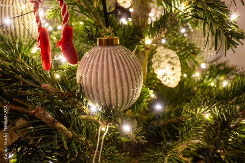 Elegant Neutral Christmas Ornament on Festive Tree with Warm Lights