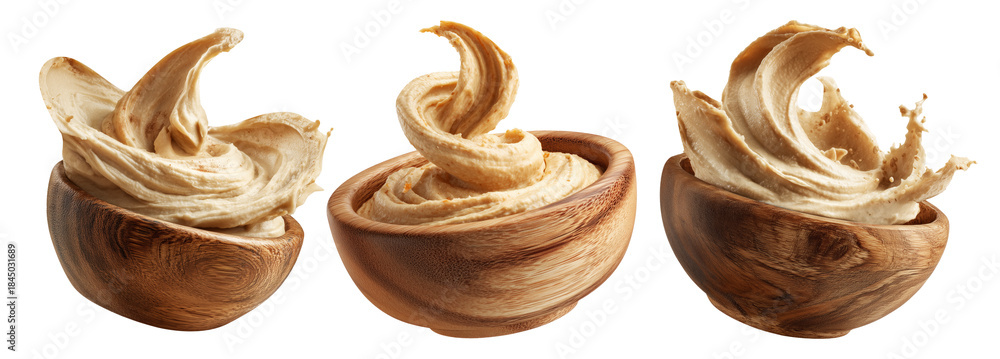 Fototapeta premium Swirled creamy hummus in wooden bowl, isolated on white transparent background. Concept of healthy vegan food and dip