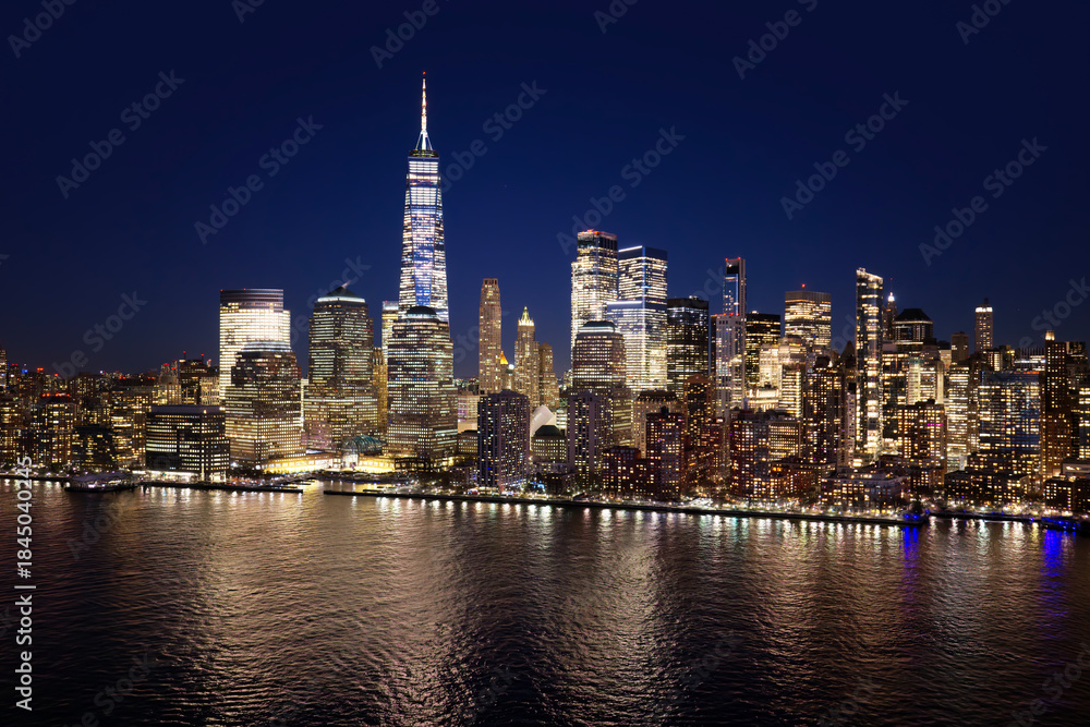 Obraz premium New York City skyscrapers forming a panoramic landscape. New York skyline with the Manhattan Tower. NYC aerial cityscape view. New York City Hudson River skyline. New York night metropolis skyline.