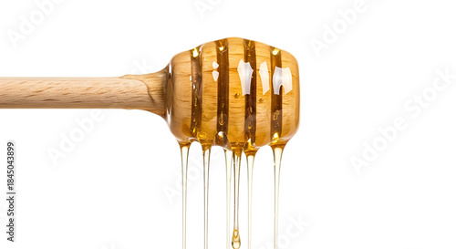 Golden honey dripping from dipper