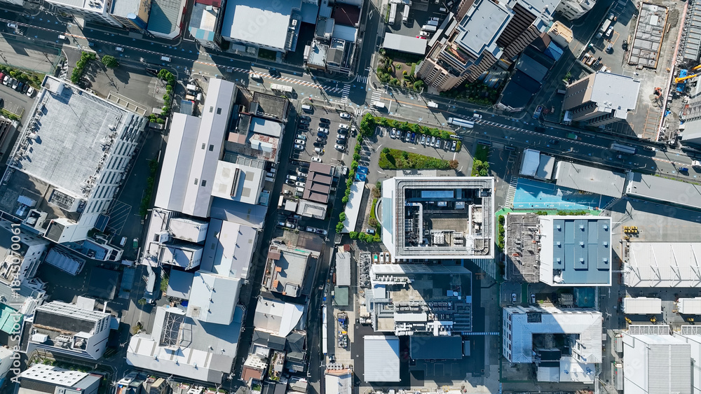 Fototapeta premium Drone directly above aerial view of modern city buildings and roads.