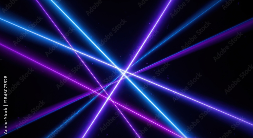 Obraz premium Vibrant neon laser beams intersecting against a dark background, creating an energetic visual display