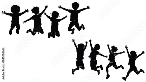 Silhouettes of happy children jumping for joy against a