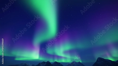 Majestic Aurora Borealis Display Over Snowy Mountain Peaks at Night