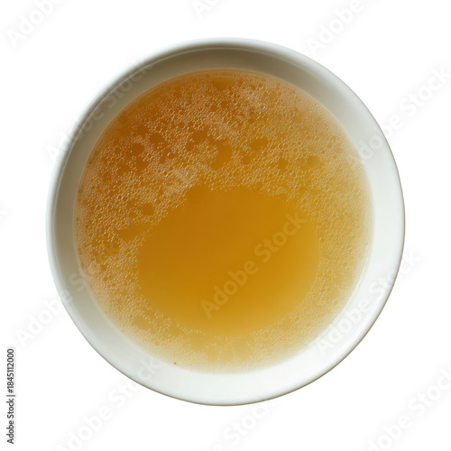 Overhead view of a white bowl filled with golden chicken broth and small bubbles food liquid, Png On White Background, Isolated on Transparent Background, Cut Out