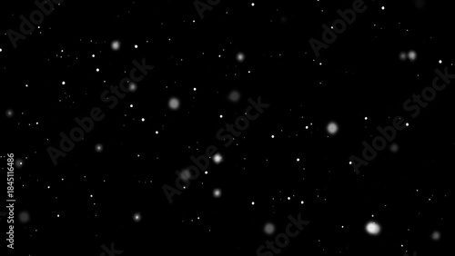 Winter freeze motion of white snow coming down, isolated on black background. Blurred snowfall texture overlay.