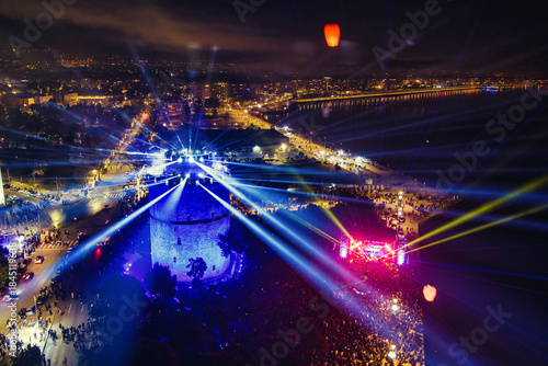 Fototapeta Naklejka Na Ścianę i Meble -  New Year’s Eve Gathering Around Thessaloniki White Tower with Festive Lights and Urban Energy