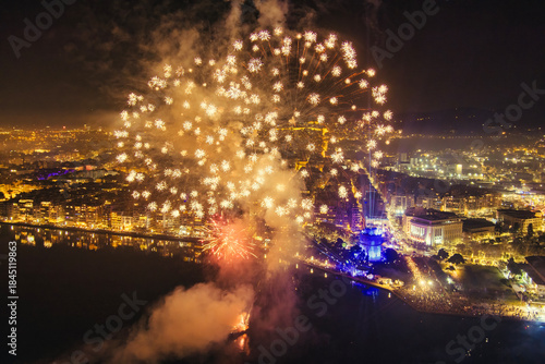 Fototapeta Naklejka Na Ścianę i Meble -  New Year’s Eve Celebration with Fireworks Over Thessaloniki’s Waterfront and Historic Tower