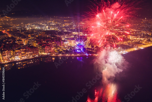 Fototapeta Naklejka Na Ścianę i Meble -  New Year’s Eve Celebration with Fireworks Over Thessaloniki’s Waterfront and Historic Tower