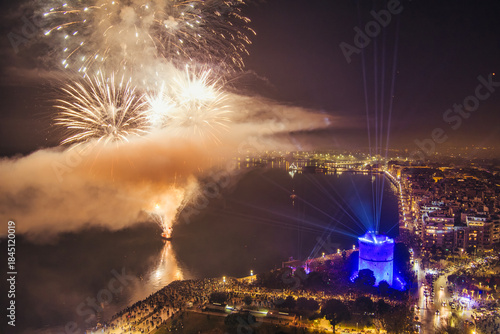Fototapeta Naklejka Na Ścianę i Meble -  New Year’s Eve Celebration with Fireworks Over Thessaloniki’s Waterfront and Historic Tower
