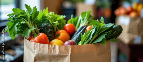 Panel kuchenny z motywem Fresh vegetables and fruits arranged in a paper bag on a table.