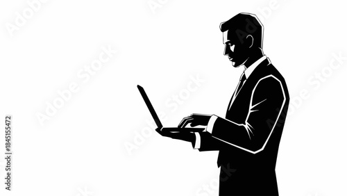 Silhouette of a businessman working on a laptop computer.