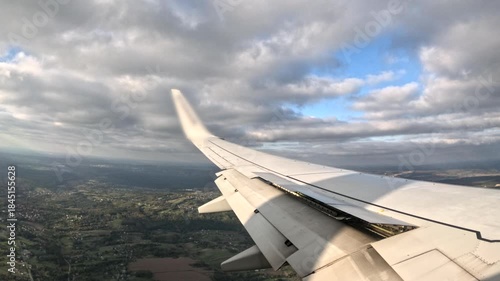Airplane wing view during approach to an unknown airport