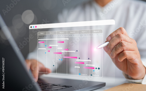 Project management and engineering concept showing a site manager using Gantt chart scheduling software to plan tasks, track progress, and support construction operations strategy.