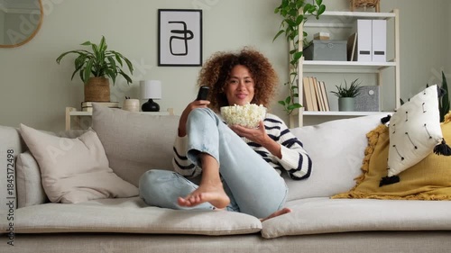 Woman with popcorn watching tv with different emotions