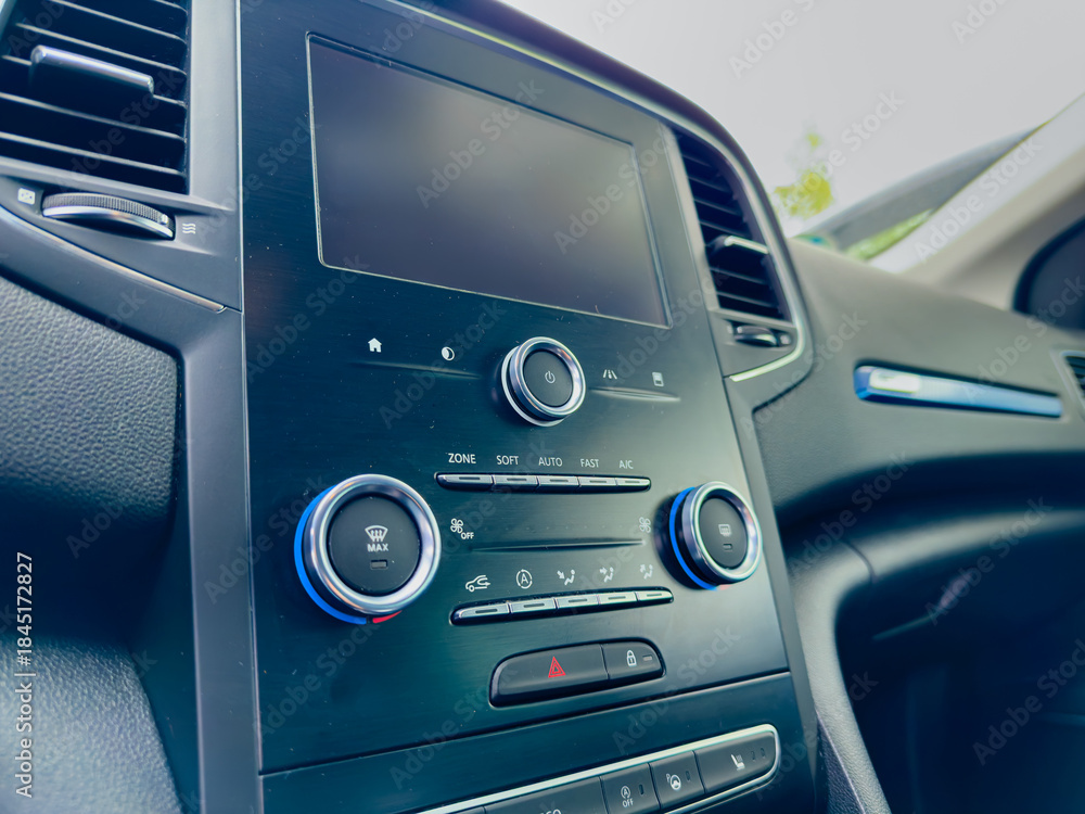 Fototapeta premium Dashboard of a modern vehicle showing controls and display during a sunny day drive in a serene environment