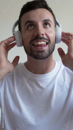 Joyful man dancing and singing with headphones