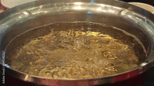 Close-Up of Bubbles Forming in Boiling Water in a Pan