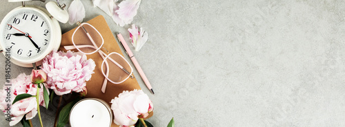Feminine Workspace with Clock, Flowers, and Stationery
