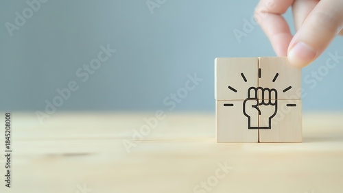 A hand places the last piece to complete an abstract representation, symbolizing strength.