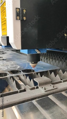 Laser cutting machine. Working process of laser cutting machine. Powerful laser beam for cutting. Cut stainless steel metal. Metal cutting machine. High precision, creating complex shapes CNC Vertical