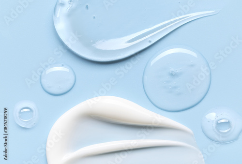 samples of cosmetic care products smear of cream and gel texture on a light blue background, moisturizing and skin care concept