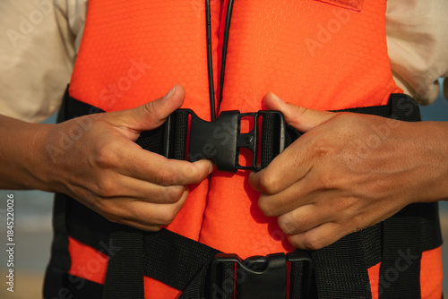 Quadro em tela Individual fastens safety gear while preparing for water activity