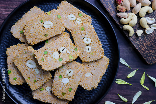 Til gajak, a traditional Indian winter sweet made with sesame seeds, jaggery, ghee, and dryfruits. Crunchy til chikki festive treat for Makar Sankranti. Tilgul. sesame candy. Copy Space. Winter food.