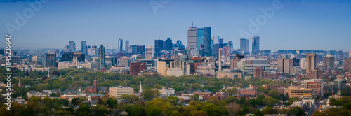 Aerial view of the John Hancock Tower and Prudential Center rise as gleaming giants above a sea of green trees and buildings., Boston, Massachusetts, United States.