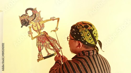Javanese puppeteer performing traditional wayang kulit show