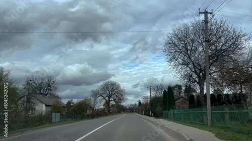 The car passes the village