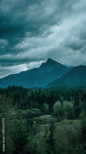 Dramatic Stormy Clouds Over Majestic Mountain Peak and Forest.