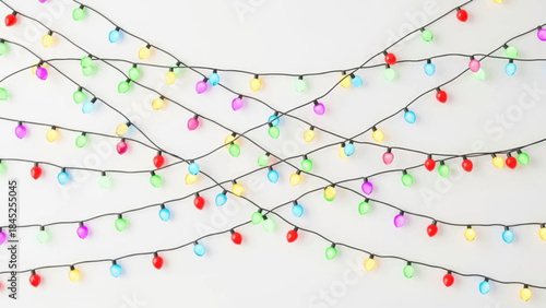 Colorful string lights draped on a white background, perfect for holiday decorations