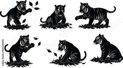 Cute tiger cub silhouettes playing with falling leaves, black wild cat illustration set, baby tiger poses isolated on white