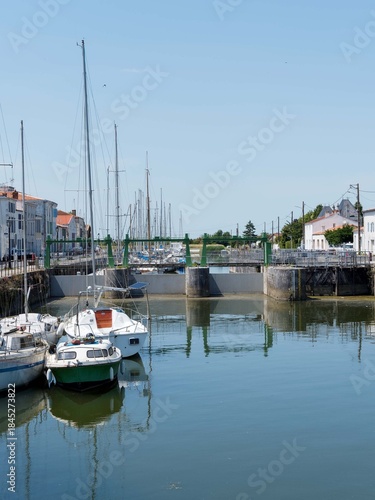 Marans in Charente-Maritime, river and sea town between marsh and sea. Lock between Quai Maréchal Foch and Quai des Fusilliers Marins on the Sèvre Niortaise canal
