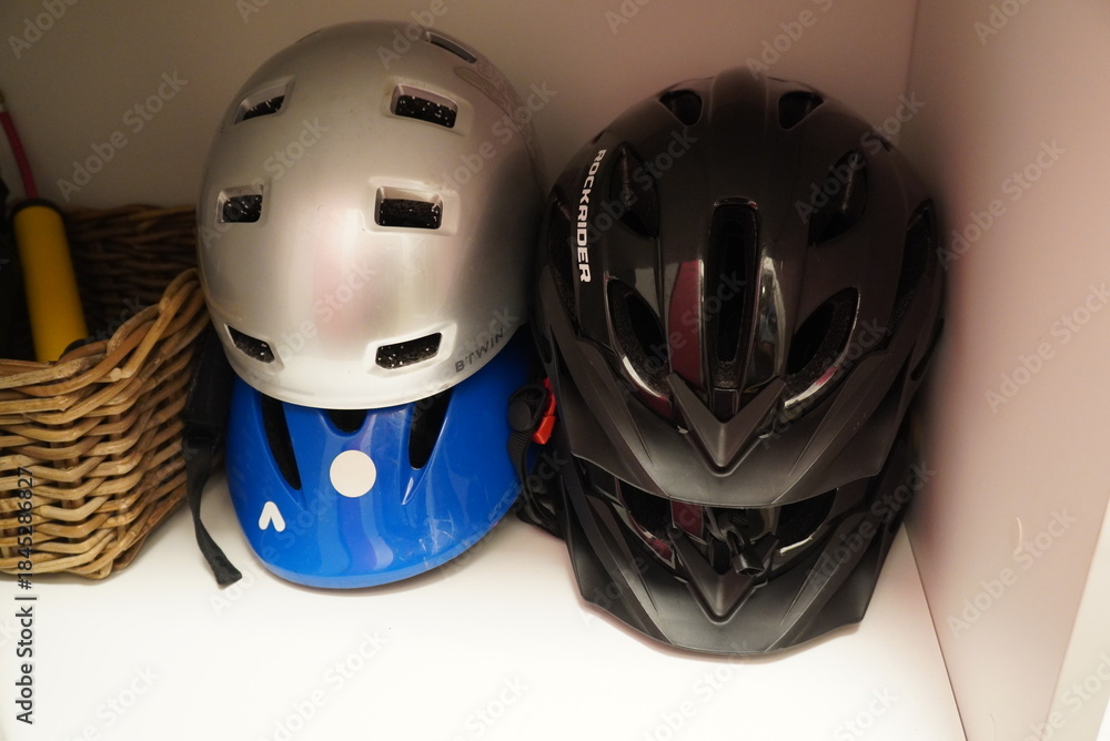 Fototapeta premium Collection of cycling helmets in various colors stacked neatly in a storage space