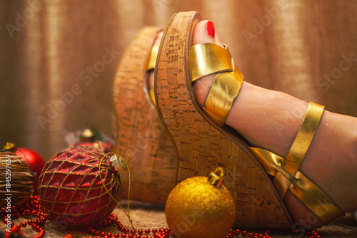 women's feet in platform sandals and Christmas tree balls