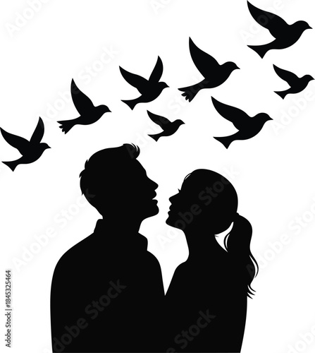 Couple gazing upwards as a flock of birds takes flight above them