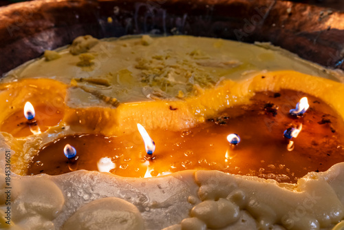 votive candles consuming itself in the wax, Lhagang Monastery, Qing Dynasty (1644-1911), Tagong , Garzê Tibetan Autonomous Prefecture, Sichuan,  China