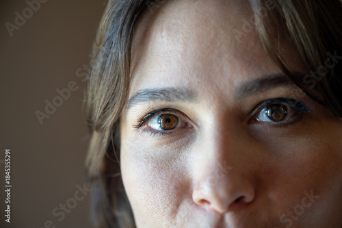 Close-up view of a woman’s gaze, highlighting expressive eyes and natural facial details.