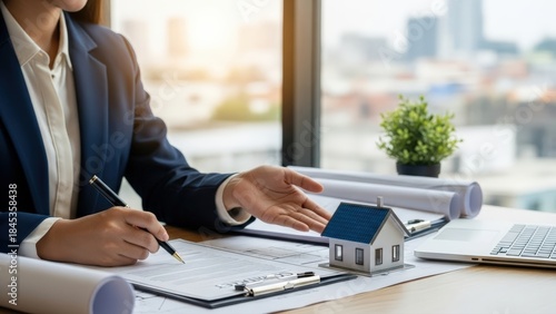 Female real estate broker advises on building project details, signing purchase contracts and discussing mortgage loans for home investment opportunities