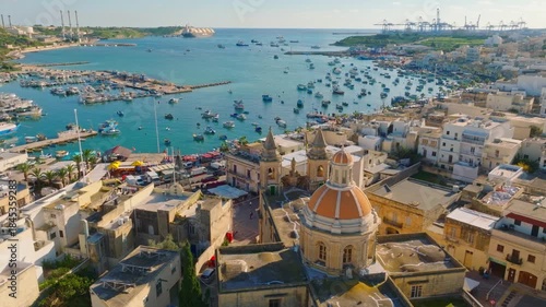 Drone view of fishing village Marsaxlokk and church. Malta island