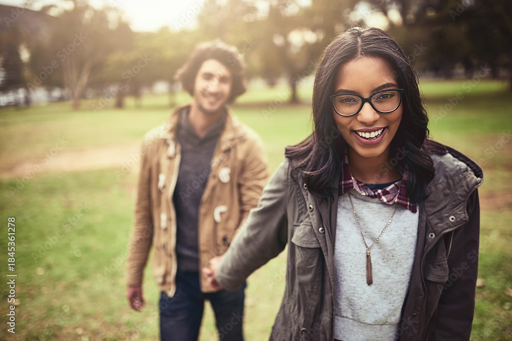Fototapeta premium Couple, holding hands and smile for walk in park with care, bonding and adventure in spring on holiday. Interracial love, man and woman with connection, portrait and outdoor on vacation in Toronto