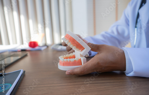 Dentist examining patient’s teeth, explaining oral health issues, reviewing x-rays, planning treatment, providing friendly dental care, diagnosis, orthodontic assessment, therapy.