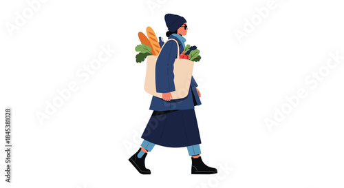 Stylish woman in a winter coat and hat walking and carrying a large tote bag filled with fresh groceries like bread and vegetables.