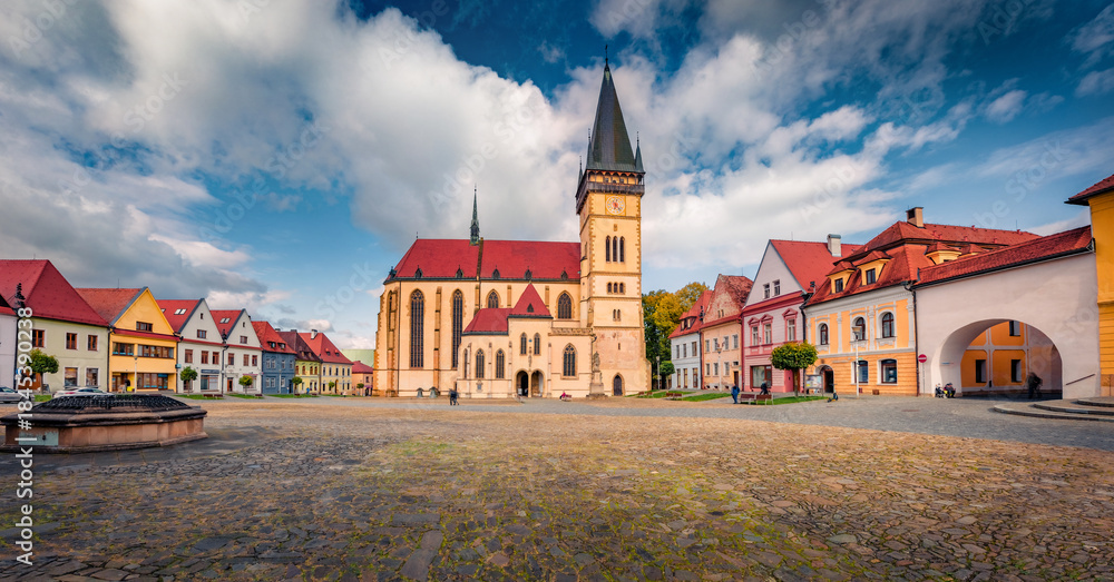 Fototapeta premium Panoramic autumn view of empty street of Bardejov town with Basilica of St Giles church on background. Wonderful autumn cityscape of Bardejov town, Slovakia, Europe. Traveling concept background.